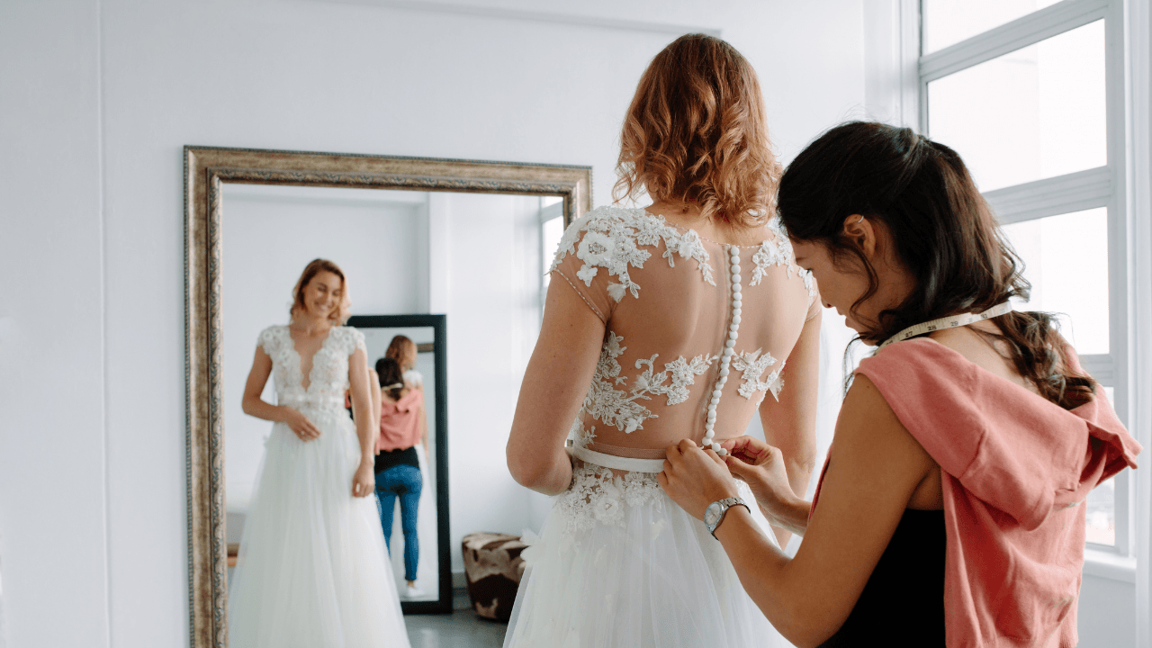 A woman trying on a wedding dress