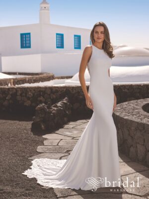 Bride in fitted white mermaid wedding dress at white resort venue