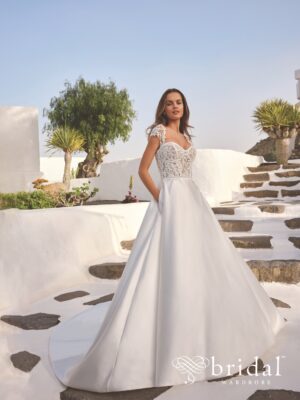 Bride in strapless satin ball gown wedding dress outdoors