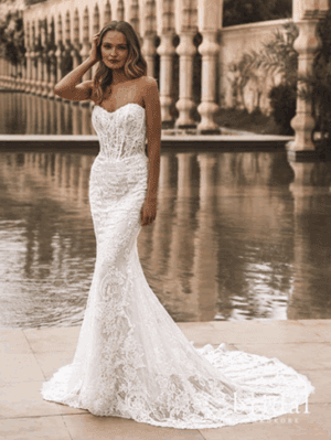 Bride in lace mermaid wedding dress with long train by columns