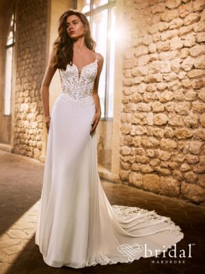 Bride wearing the GINORA Étoile chiffon A-line wedding dress with a V-neckline, spaghetti straps, princess-boned bodice, basque waist and cathedral train.