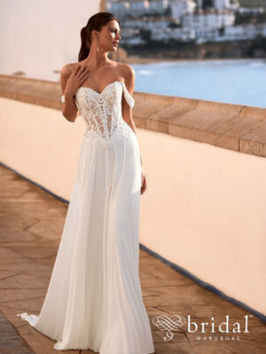 Bride wearing the FELINNA A-line wedding dress from the Love collection with a sweetheart neckline, detachable off-the-shoulder sleeves, basque waist and chapel train.