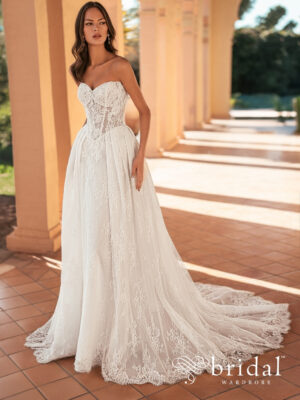 Bride wearing the URVIKA Blue by Enzoani Chantilly lace ballgown with a strapless sweetheart neckline, princess-boned bodice, basque waist and royal train.