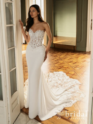 Bride wearing the HEATHER Élysée column wedding dress with a strapless sweetheart neckline, princess-boned bodice, sculpted basque waist and cathedral train.