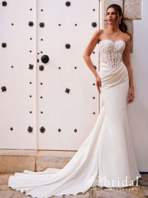 Bride wearing the FOSIRA fit-and-flare wedding dress from the Love collection with a sweetheart neckline, structured bodice, asymmetric ruching and court train.
