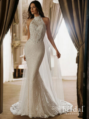 Bride wearing the ELOWEN PEN·LIV trumpet wedding dress with a halter neckline, princess-boned bodice, basque waist and sweeping detachable cathedral cape.