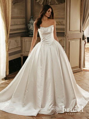 Bride wearing the EMMELYN PEN·LIV ballgown wedding dress with a strapless scoop neckline, ruched bodice, basque waist, delicate floral embellishments and cathedral train.