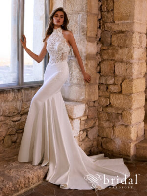 Bride wearing the GABRIANNA Étoile fit-and-flare wedding dress with a halter neckline, princess-boned bodice, defined basque waist, detailed back and chapel train.
