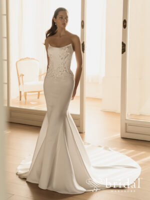 Bride wearing the HAVARA Élysée column wedding dress with a strapless scoop neckline, embellished boned bodice, natural waist and sweeping cathedral train.