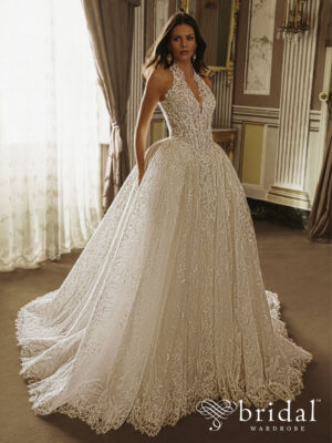 Bride wearing the ESMIRA PEN·LIV ballgown wedding dress with a plunging neckline, detachable halter straps, princess-boned bodice, basque waist and cathedral train.