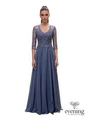 Woman wearing Style 1259 in Vintage Indigo, a floor-length chiffon A-line gown with floral beaded bodice, V-neckline, sheer three-quarter sleeves and illusion back.