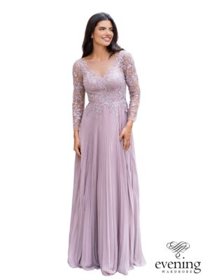 Woman wearing Style 1132, a floor-length A-line evening gown with floral lace bodice, illusion V-neckline, long sheer lace sleeves, chiffon skirt and deep V-back.
